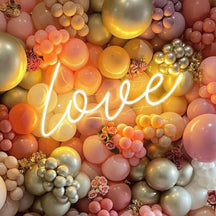 Love neon sign in warm white with balloons.jpg__PID:ce87256a-656a-496a-b536-1a1b299de683