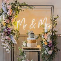 Snow white Mr and Mrs wedding neon sign and spring cake.jpg__PID:fdd3794f-1103-4f68-aee5-ad513278ab58