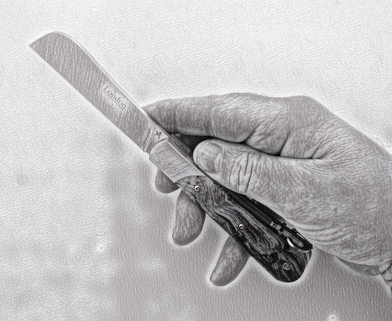 A 11 cm handle London knife shown with hand for proportion