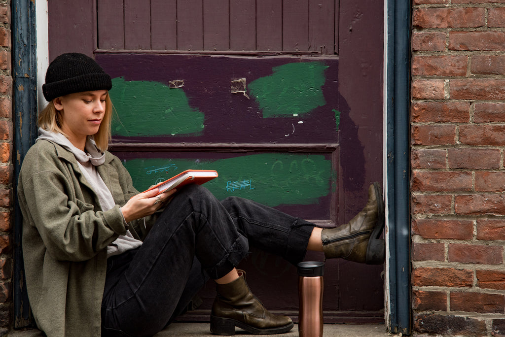Girl in a back alley nook journaling