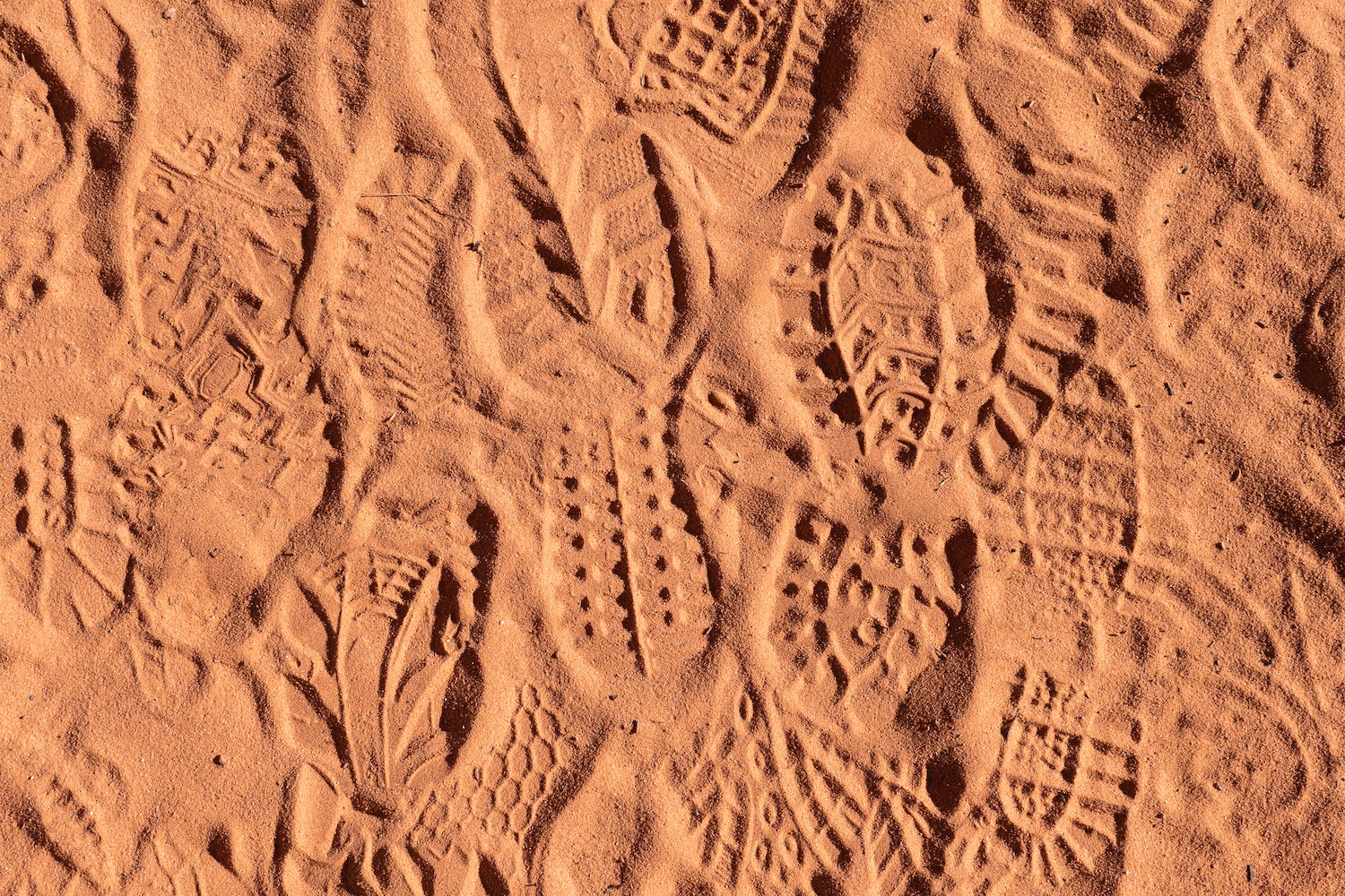 footprints in the orange dirt of utah