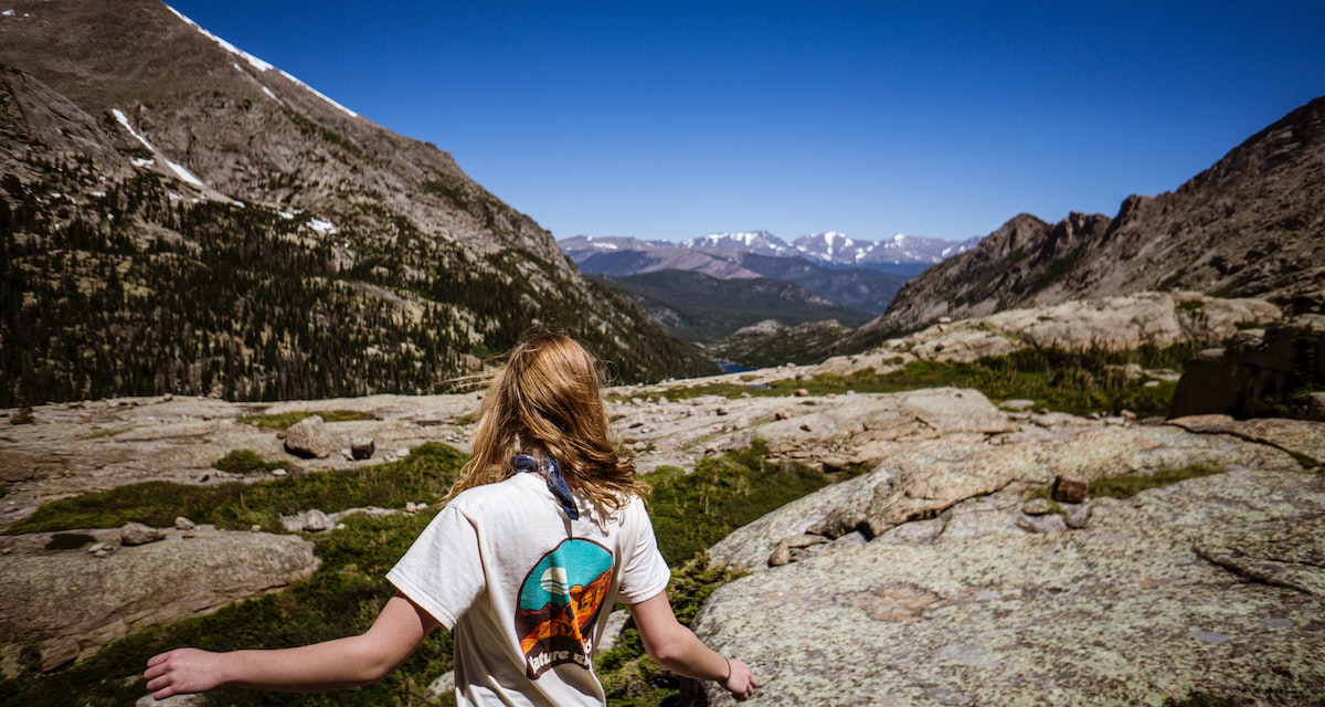 guy with long hair on a hike