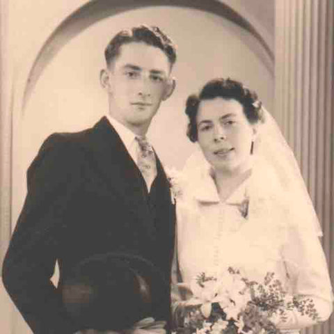The digital image file of a formal wedding portrait shows digital artifacts that appear when jpeg is re-saved multiple times. 