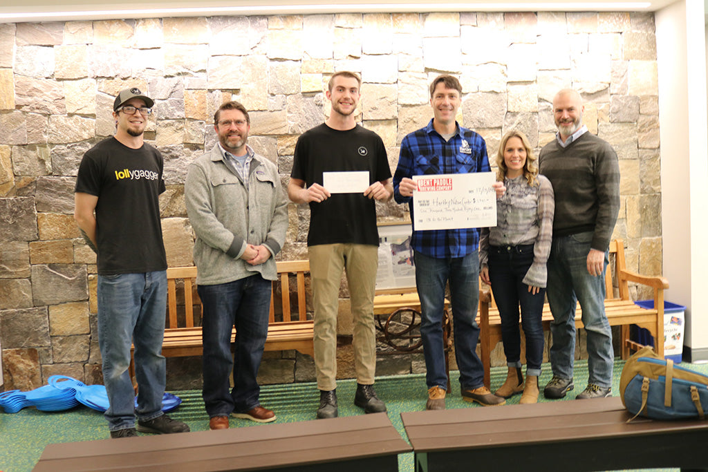 Loll team members gift a check to Hartley Nature Center