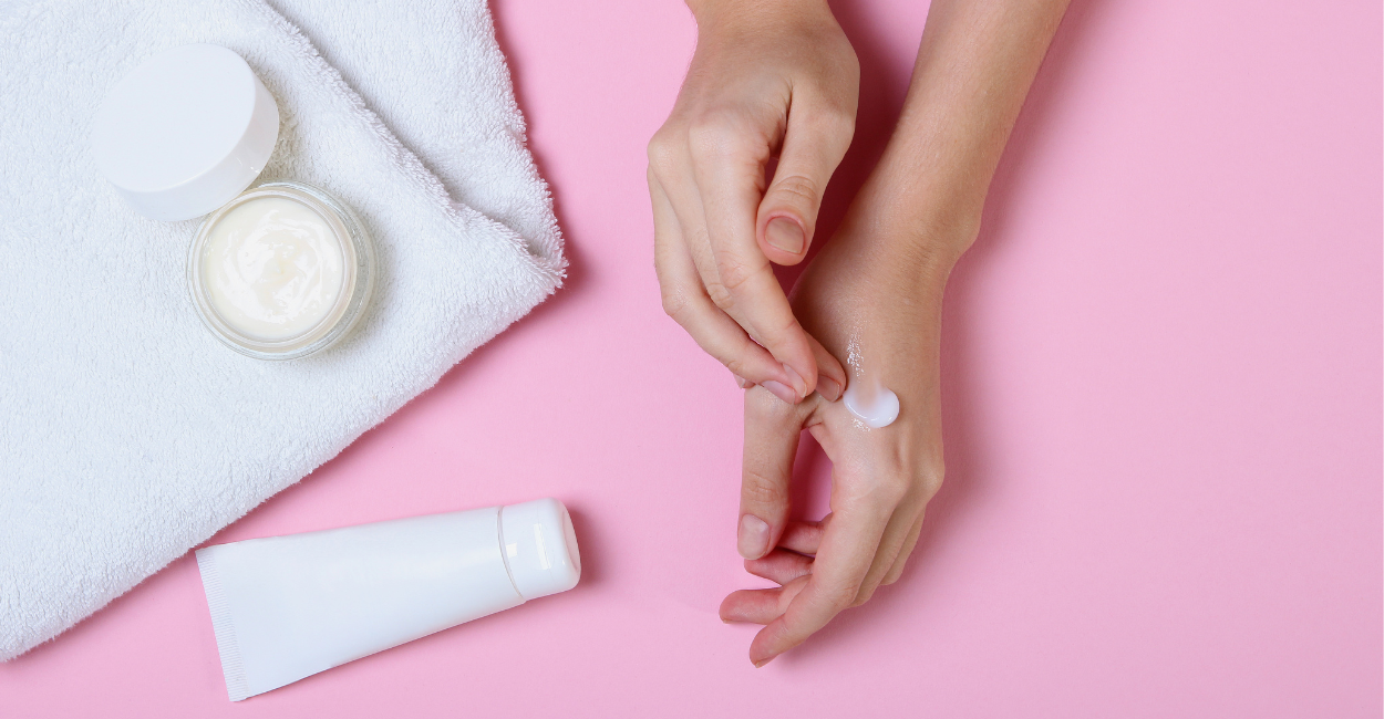 A woman applying CBD lotion to her hands