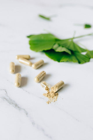 Herbal capsules filled with kratom powder to showcase a convenient, tasteless dosing method.