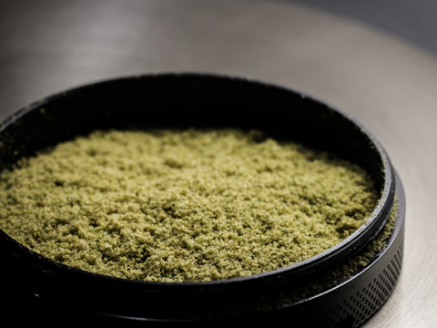A grinder filled with cannabis kief, a powdery substance used when live resin is made