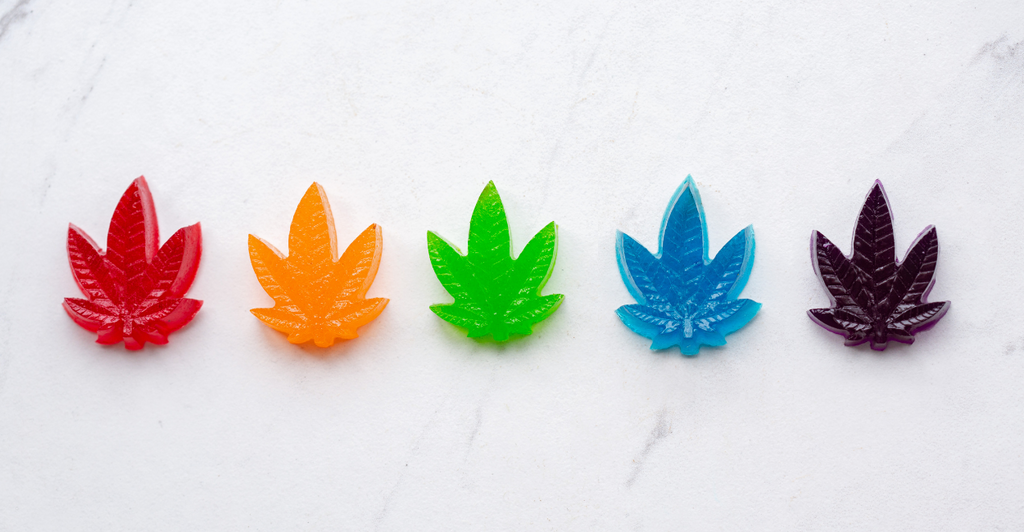 A rainbow colored collection of hemp leaf shape delta-9 gummies