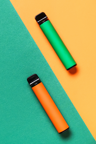 Two Hemp THC Vape pens sitting on contrasting backgrounds