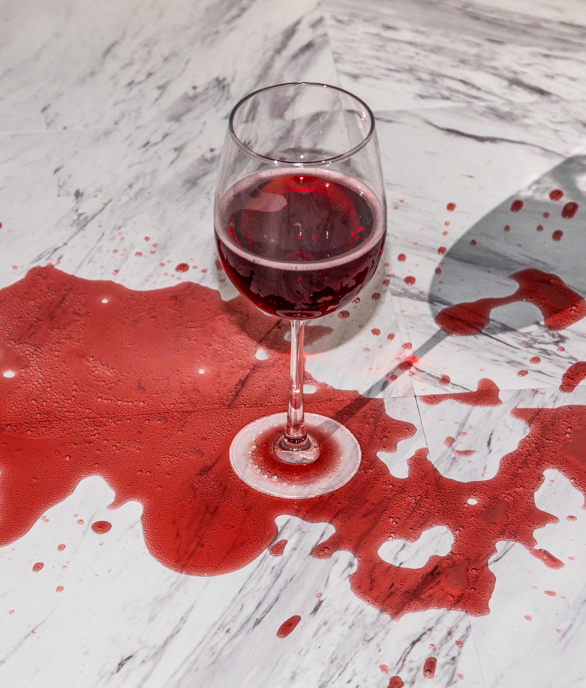 Red wine spilled over glass.