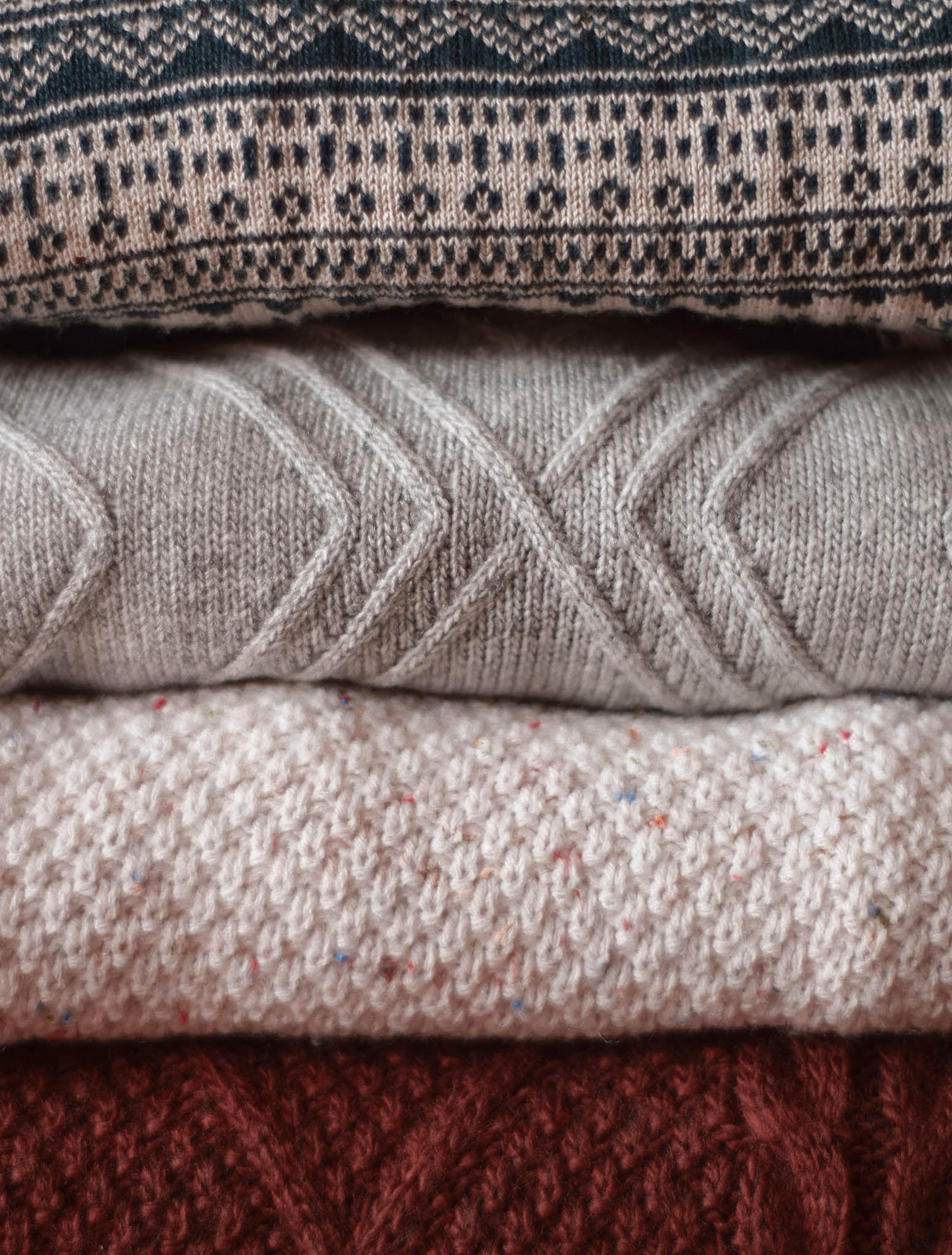 Folded stack of knit sweaters