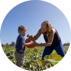 Mother and Son Picking Pumpkins in a Pumpkin Patch