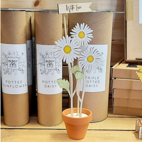 Wooden daisy decoration in a terracotta pot