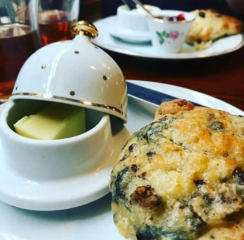 Flavoured scone and butter dish with butter, tea inc menu