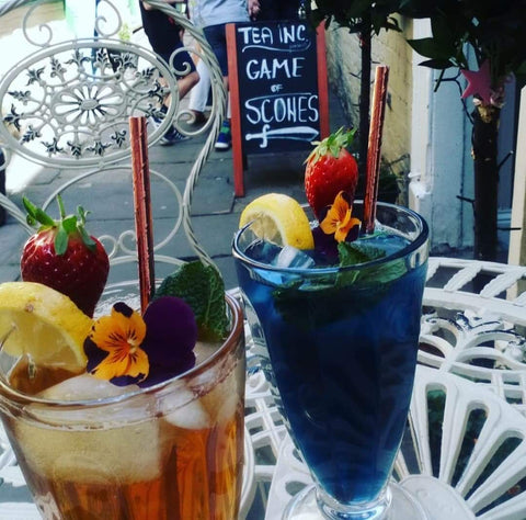 Iced teas in fancy glasses with fruit garnish