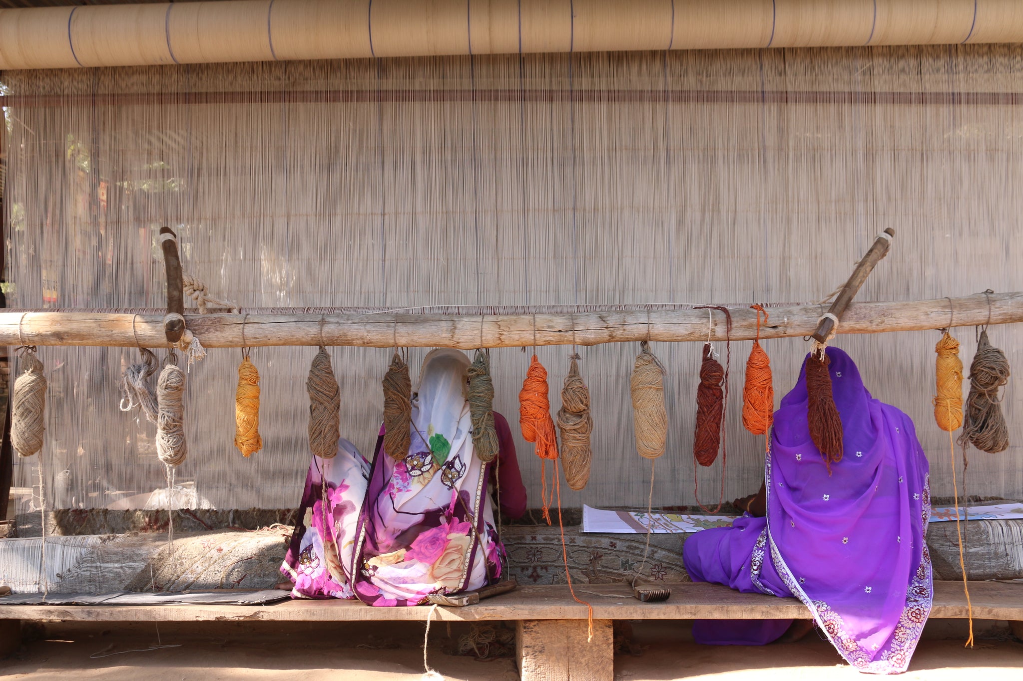 Indian woman weaving on a vertical loom 