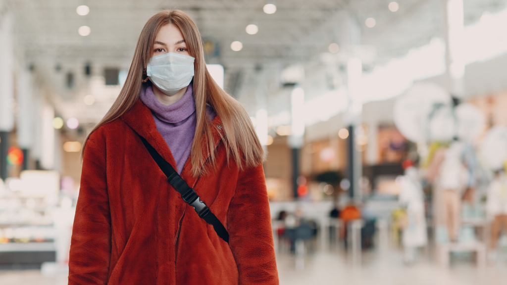 Woman wearing a surgical mask indoors