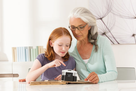 Woman and child using Visolux + to read together