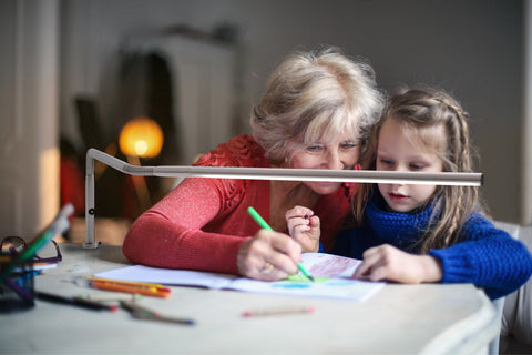 Grandmother, drawing with her grand-daughter using the Slimline table lamp