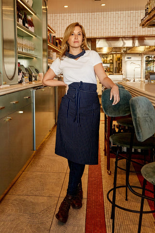 A chef wearing a waist apron while cooking