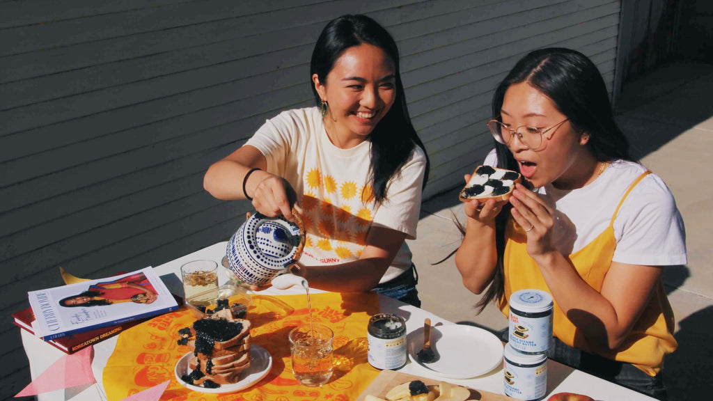 Co-founders Ashley (left) and Hedy (right) enjoying Black Sesame Crunchy Butter on toast and apples.