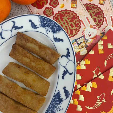 Gluten free nian gao on a Chinese plate surrounded by red envelopes
