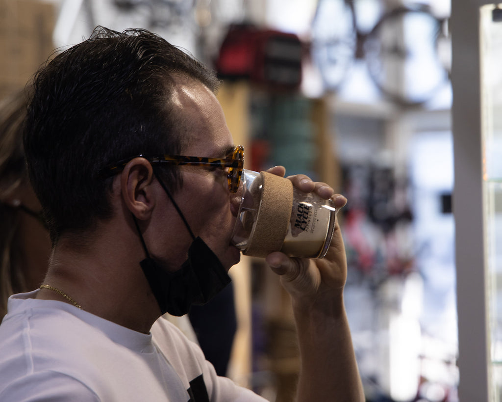 Rigoberto Uran drinking coffee from the Mack Cycle Keep Cup inside Mack Cycle in Miami