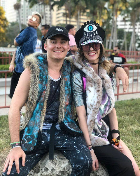 two people wearing faux fur hoods sitting together