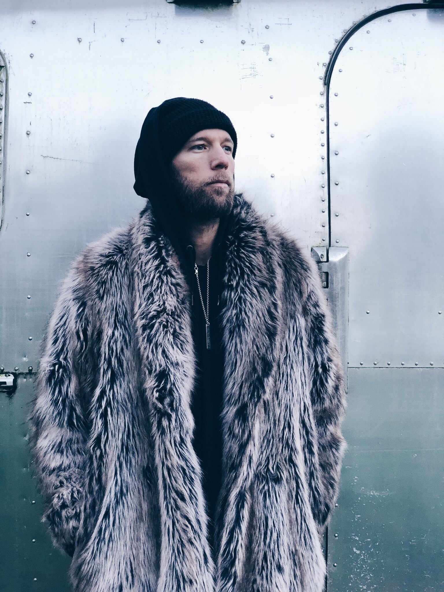 man wearing beanie and faux fur coat