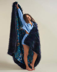 Woman holding the reversible Nicobar Pigeon Faux Fur Blanket