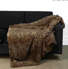 Faux Fur Leopard Brady Blanket hanging on black couch