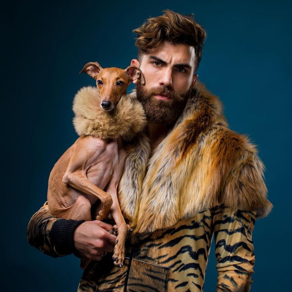 Guy holding dog while wearing faux fur coat