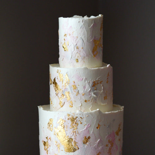 One Tier Buttercream Cake Gilded in Gold Leaf and Topped with Buttercream  Swirls and Sprinkles