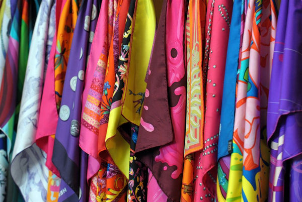 A collection of silk scarves with differnt colors and patterns