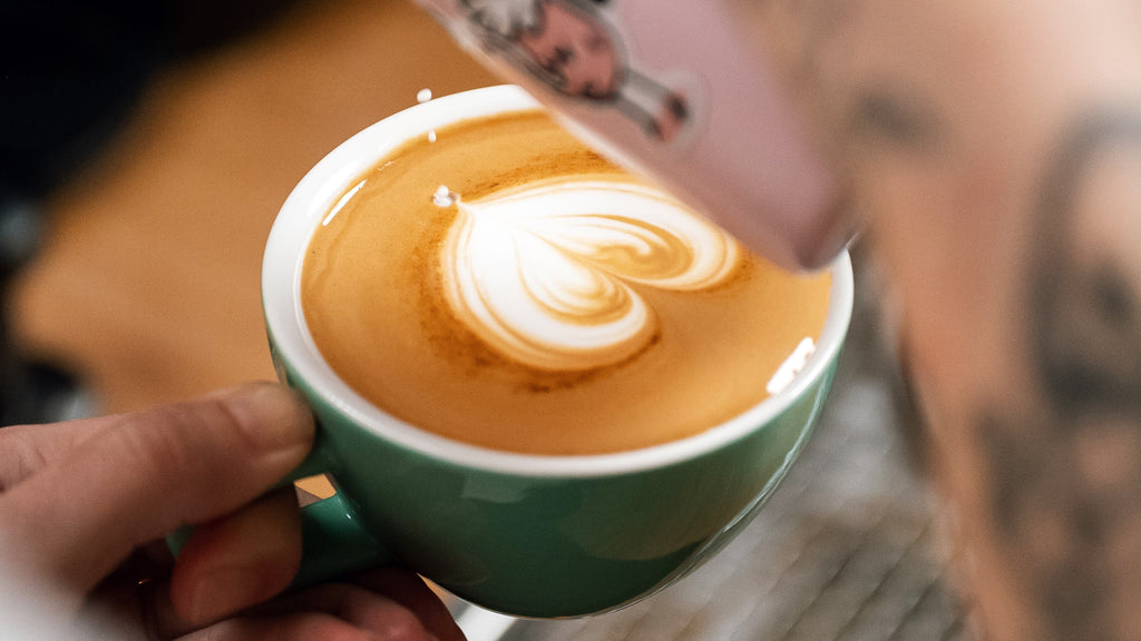 latte heart pour with steamed milk and cup