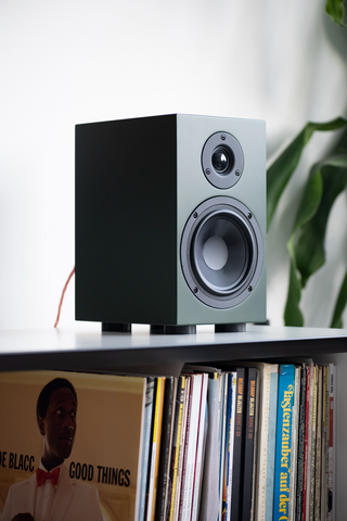 A single Pro-Ject Speaker Box 5 S2 on top of a shelf of records