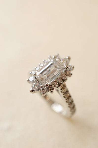 Emerald Cut Diamond Cluster Ring With Graduated Halo