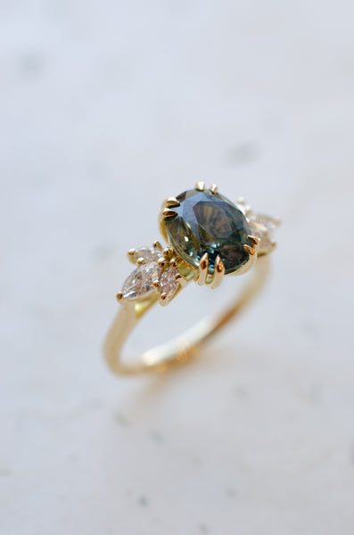 Teal sapphire oval engagement ring 18ct yellow gold