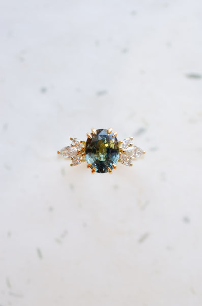 Teal sapphire oval engagement ring 18ct yellow gold