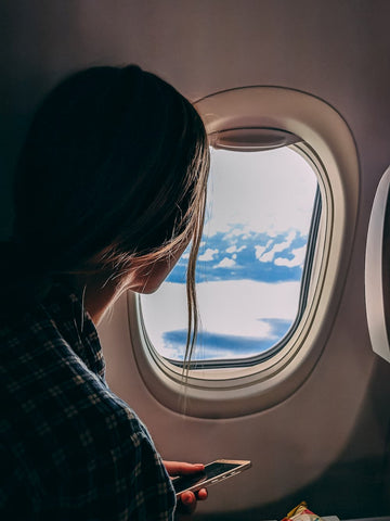Woman looking out of aircraft window