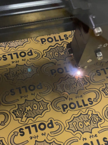 Laser cutting machine and details that read Power to the Polls