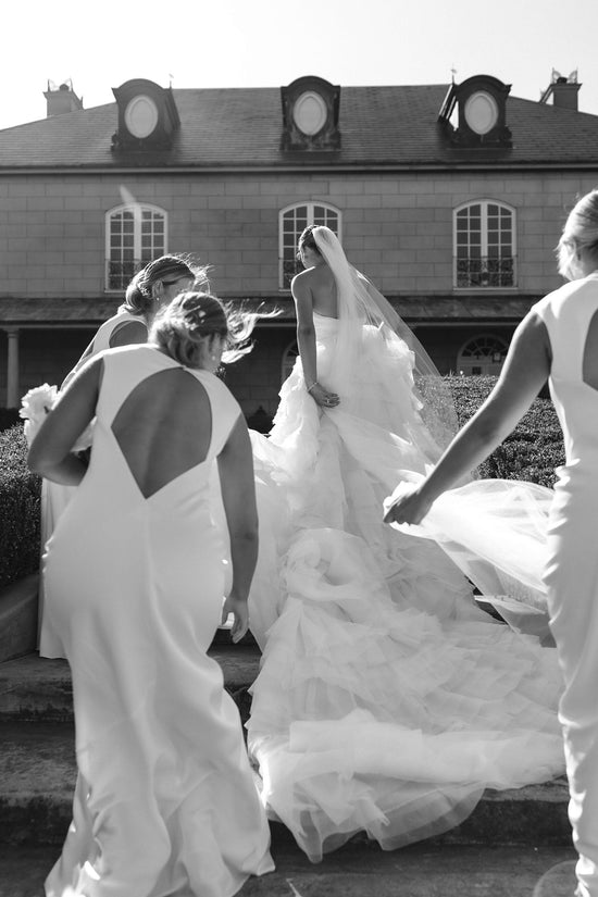 BRIDESMAIDS FIX TRAIN OF BRIDAL GOWN