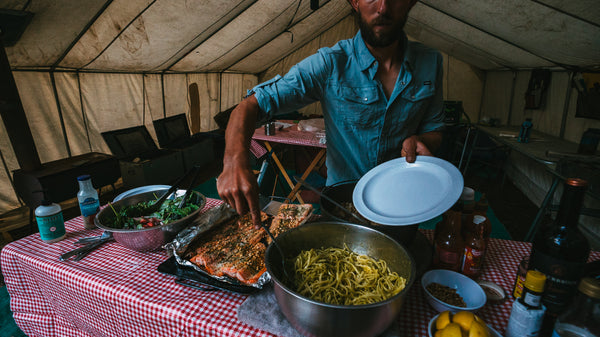 Guide Kaleb Bass, serving dinner on a multi day river trip on the Grande Ronde River.