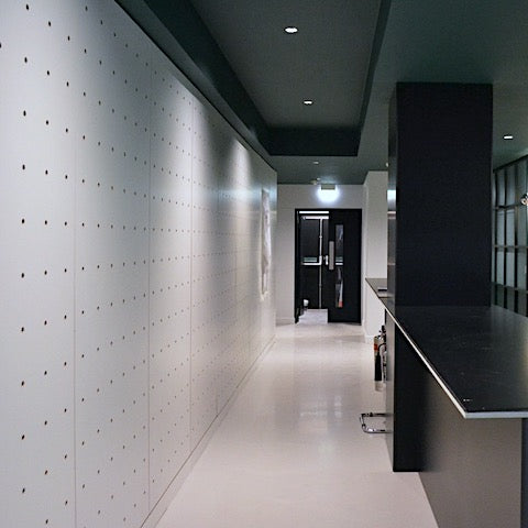 Pegboard wall in white for an office lobby in Soho London by Kreisdesign. Architects: Universal Design Studio