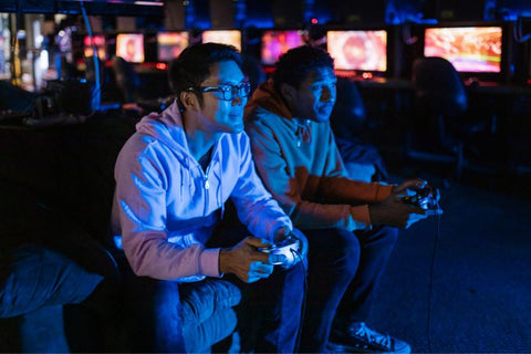 two gamers playing with a video game controller