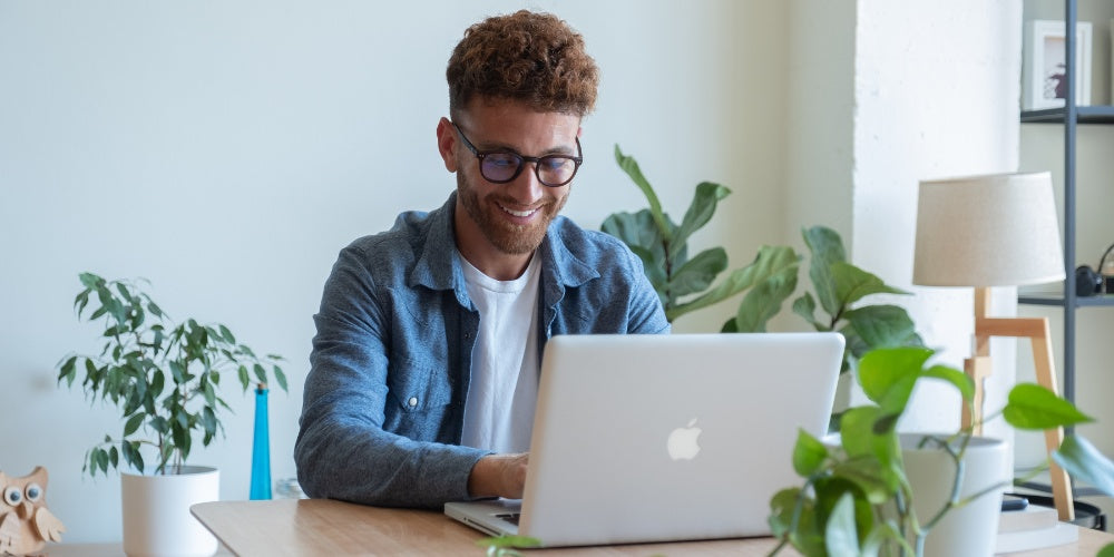 man wearing Horus X anti-blue light glasses while working on his computer