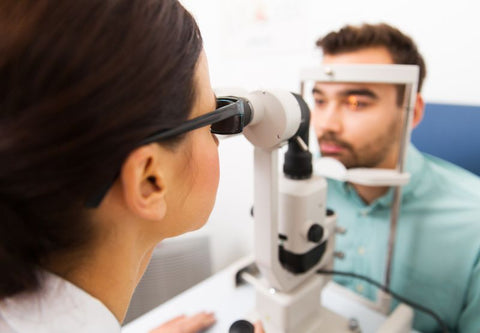 Ein Augenarzt untersucht einen Patienten mit einem Messgerät