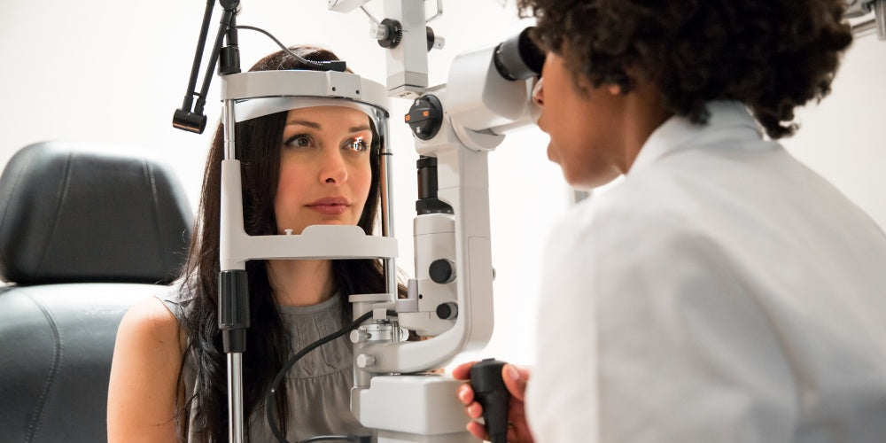 a woman having an annual eye exam by an optometrist