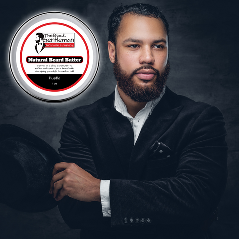 A stylishly groomed beard with a jar of 'The Natural Beard Butter' by The Black Gentleman Grooming Co.™ in the background, showcasing the product's promise of nourishment, shaping, and protection for beards.