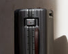 Sleek polycarbonate carry-on suitcase with shadow lighting